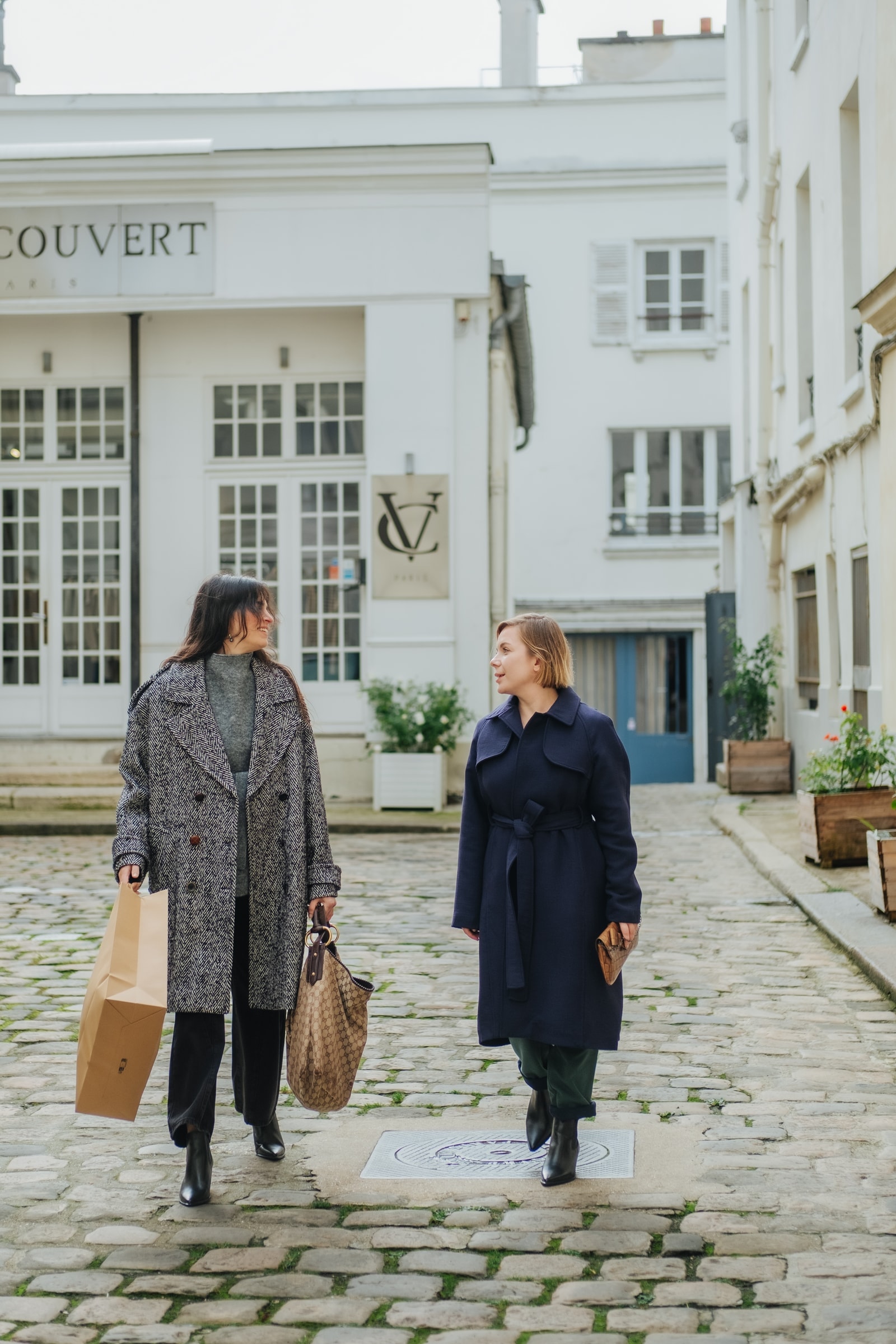 Clients walking through a Paris boutique street with luxury shopping bags